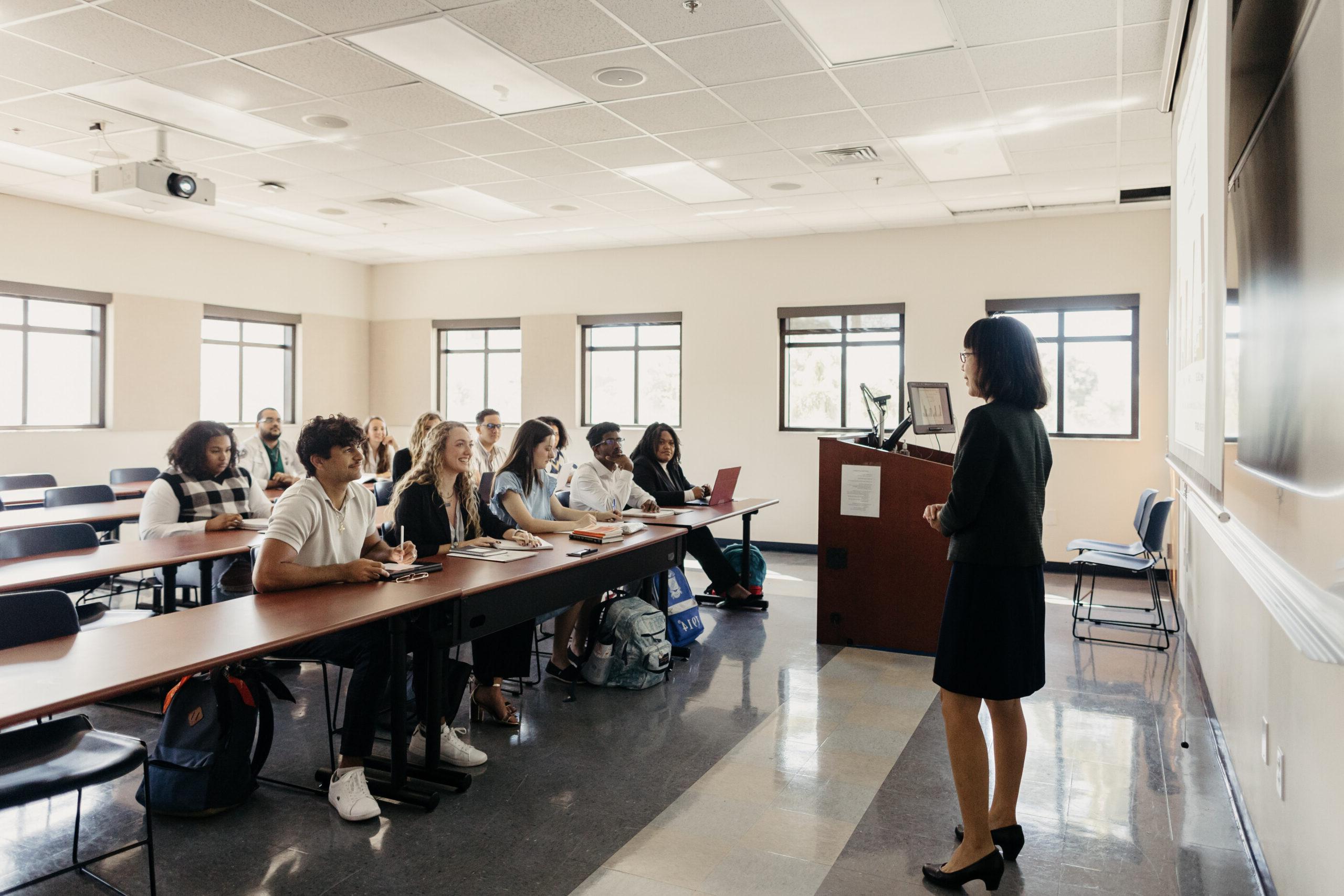 a professor speaking to a classroom full of students